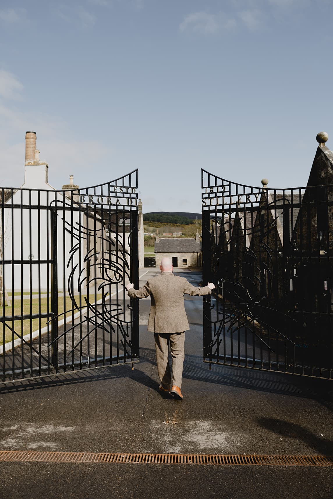 The Brora Distillery entrance in Scotland featuring the branded gates