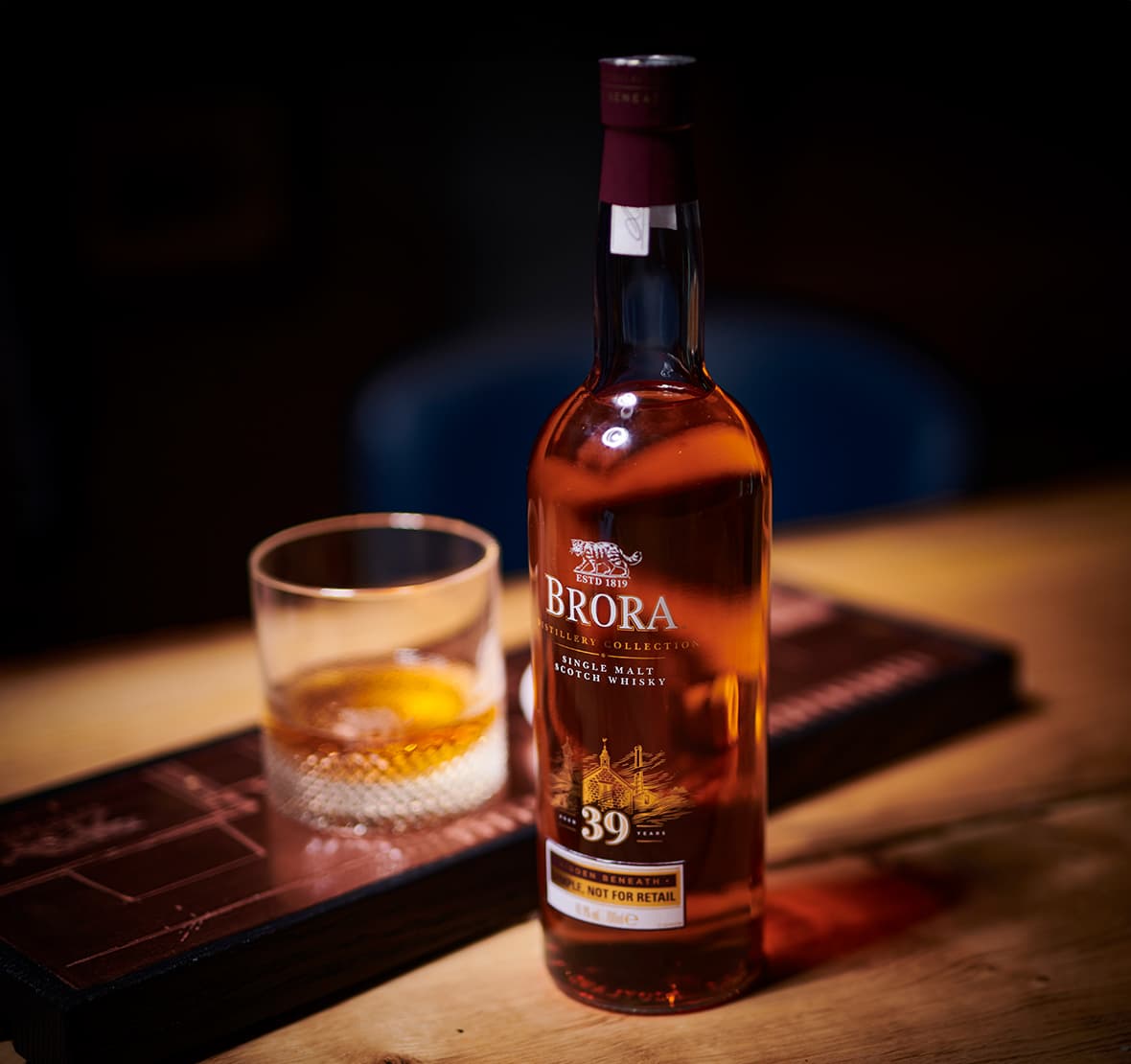 A bottle of Brora 39 Year Old and a glass on a table