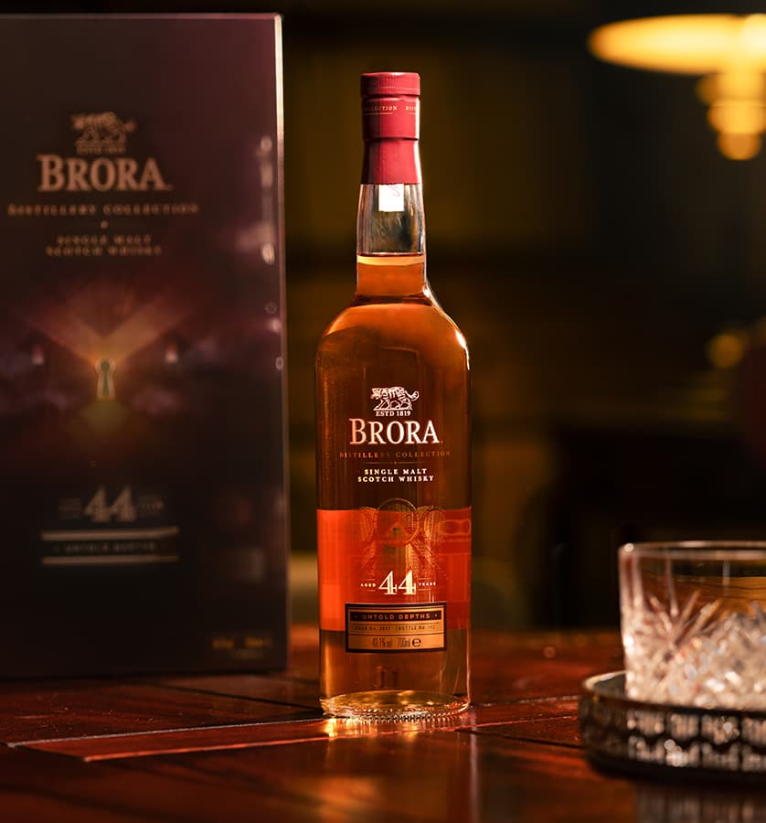 Brora 44 year old bottle on a table and the packaging behind the bottle