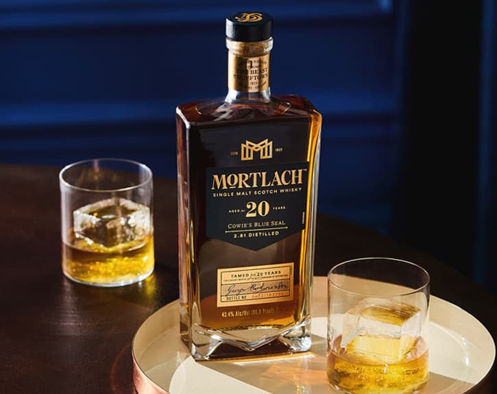 Mortlach 20​ Year Old on a table with two glasses of whisky one in front and one at the back of the bottle