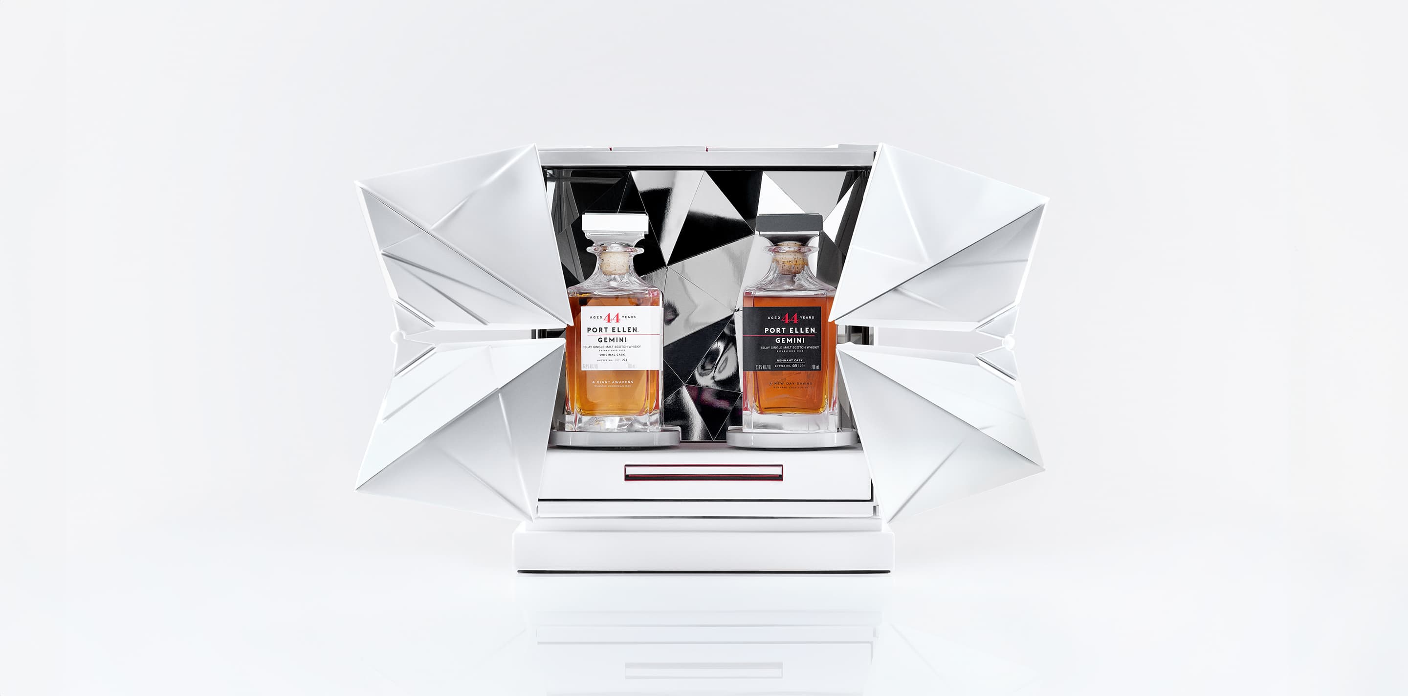 Two bottles of gemini port ellen whisky in a futuristic white case