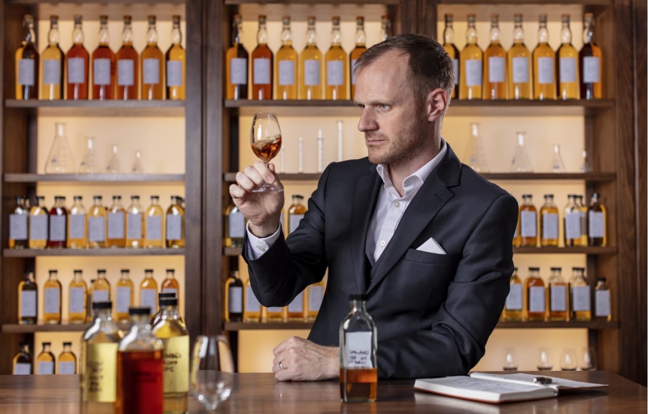 Dr Craig Wilson, Master Whisky Blender pictured inspecting the whisky in a glass