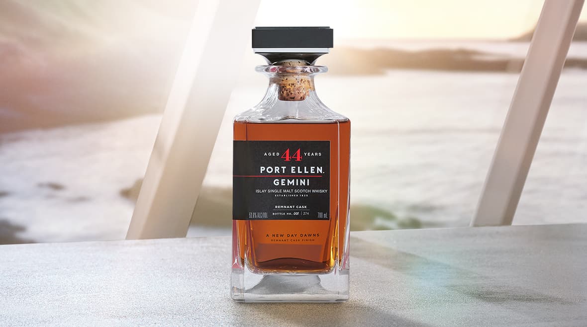 Bottle of gemini remnant whisky from port ellen in front of a window with ocean view