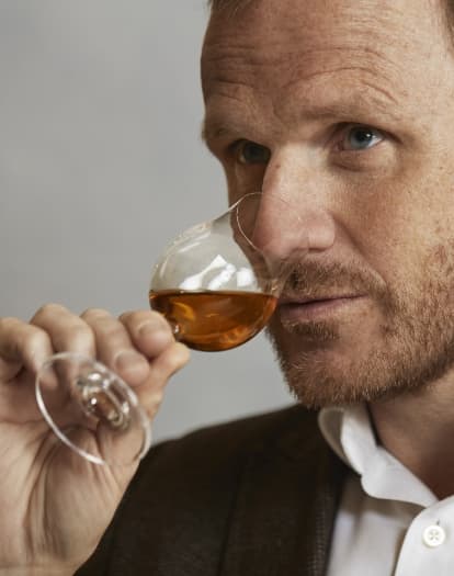 a close up image of Dr Craig Wilson smelling a neat serve of whisky