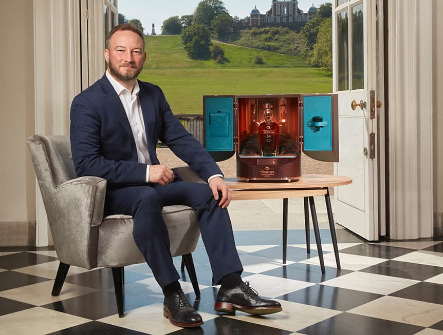 Ewan Gunn sat beside a box of Brora Single Malt Whisky Triptych